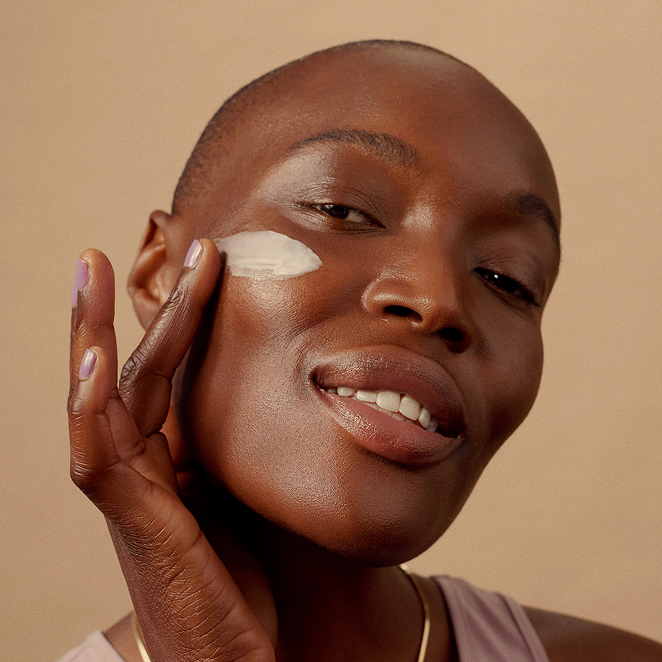 Woman applying moisturizer with ceramides