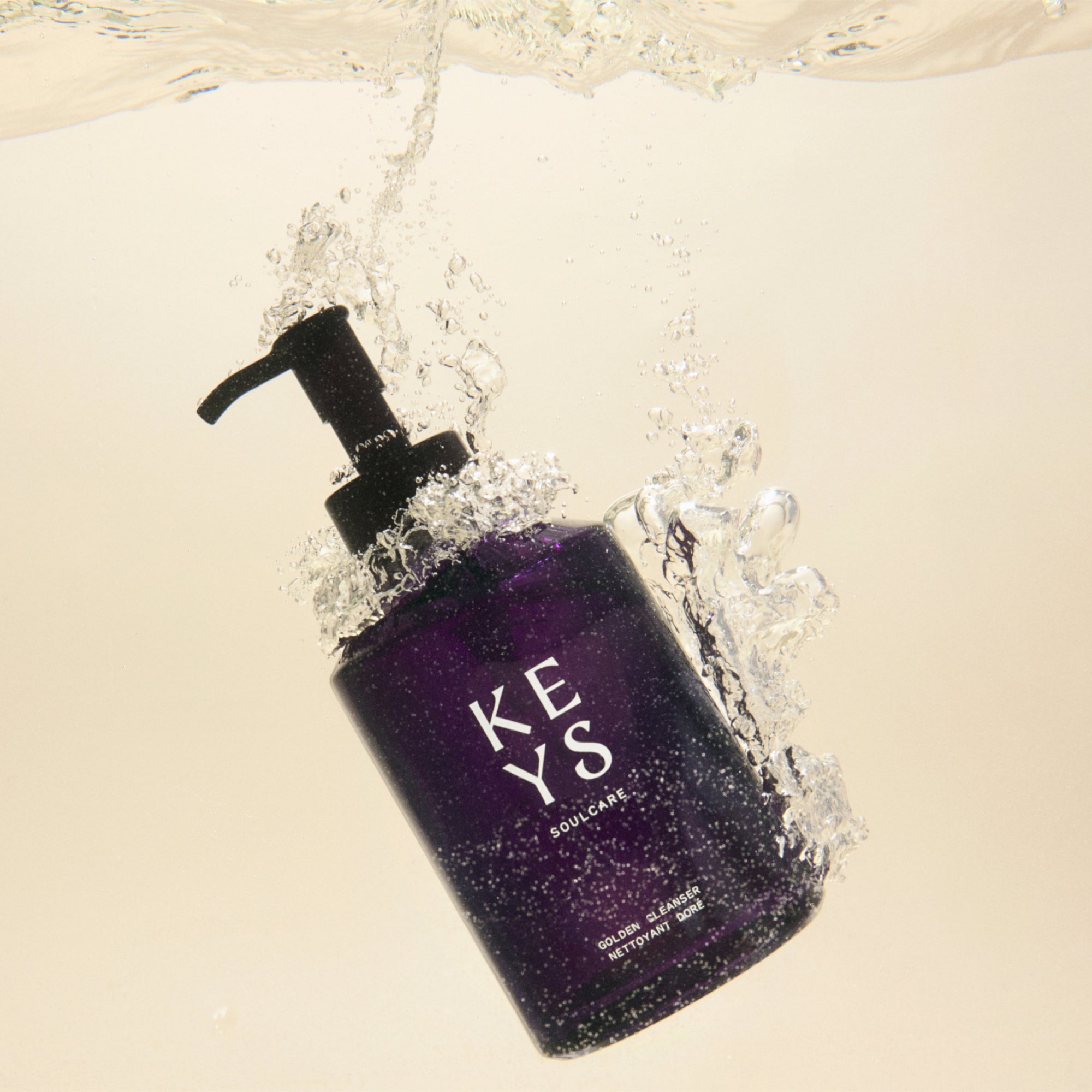 Golden Face Cleanser with Manuka Honey bottle image in water