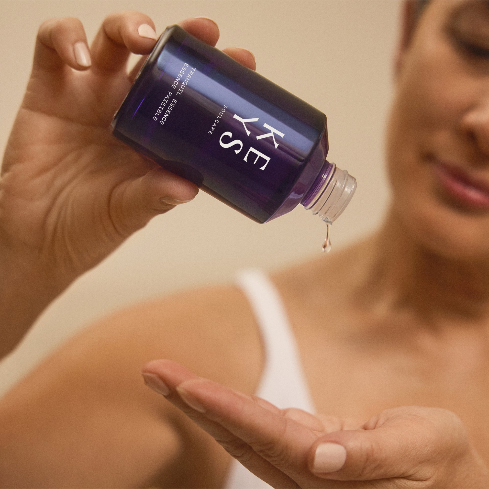 woman applying Tranquil Essence facial toner