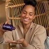 Alicia Keys Pouring Exfoliating Powder into Hand